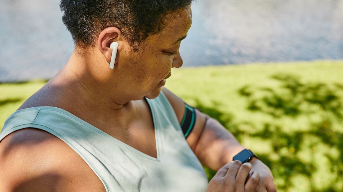 female outdoors checking fitness watch