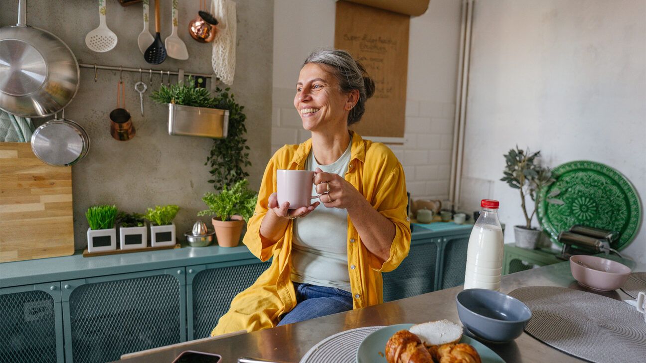 Female drinking coffee in kitchen