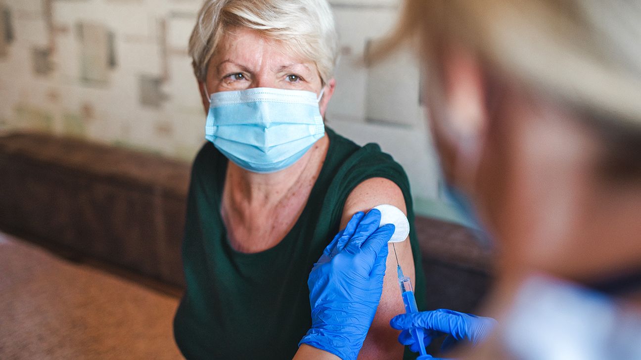 Older female receiving a shingles vaccine shot