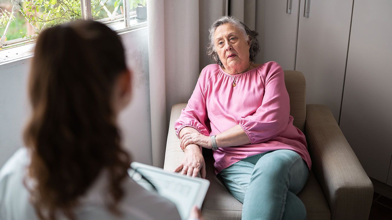 senior female listening to doctor