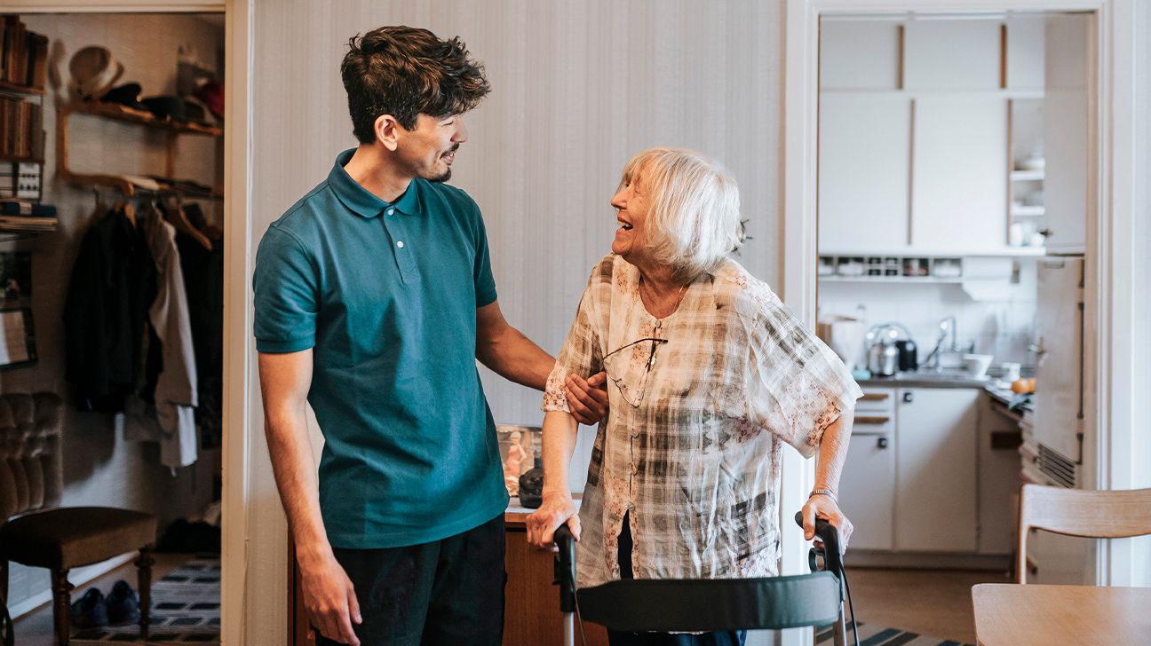 Male healthcare worker talking to senior female