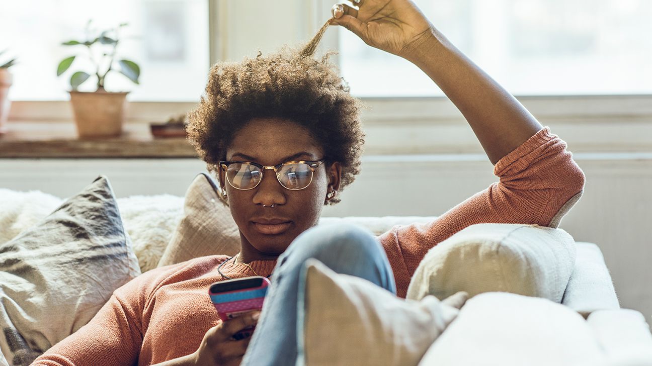 Person looking at phone for online therapy