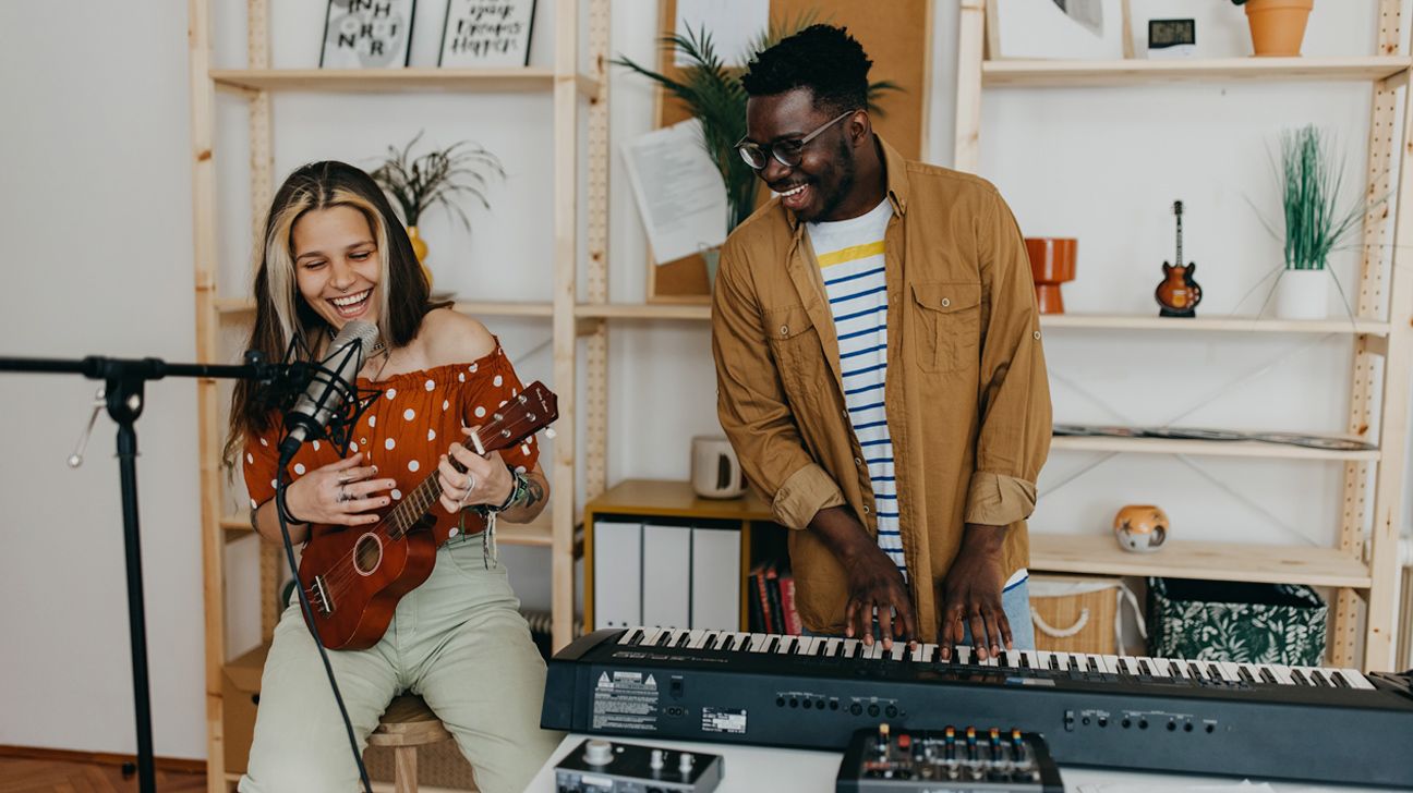 two people enjoying playing music