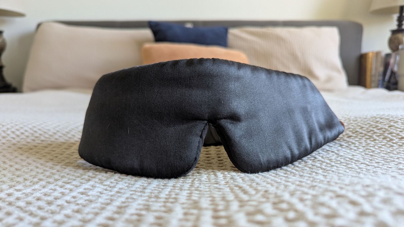 Lunya sleep mask sitting on bed