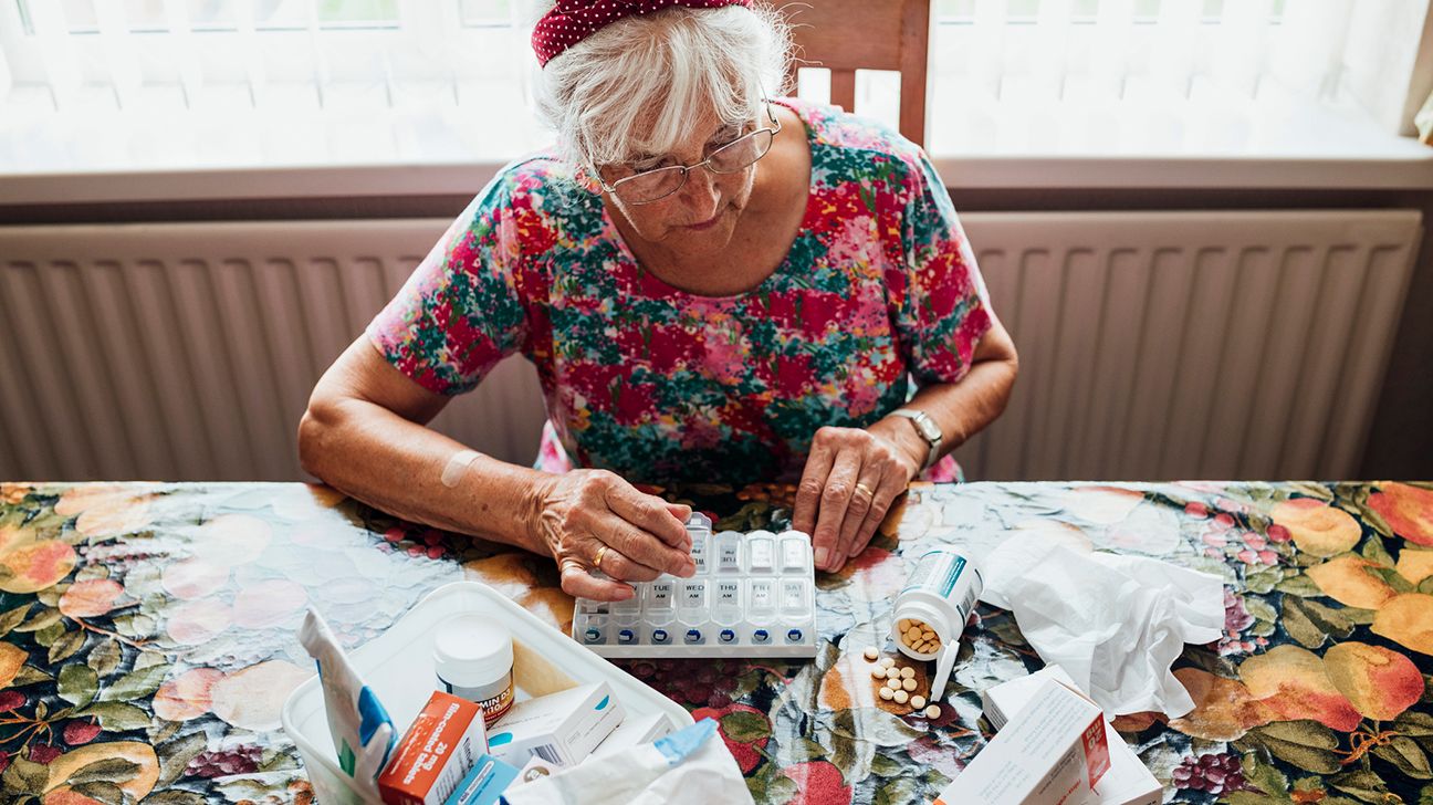 senior female sorting medicine