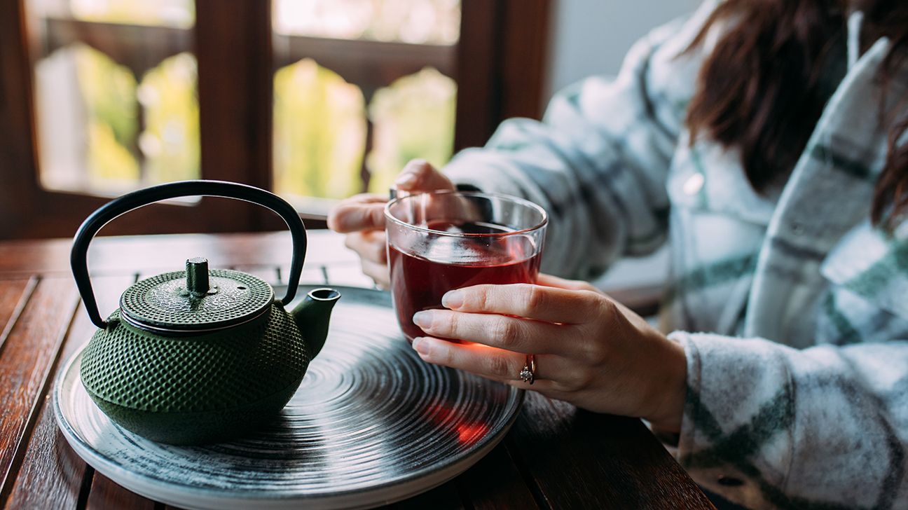 Woman holding a warm cup of herbal tea