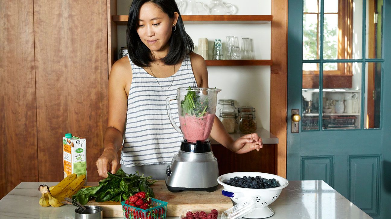Female making a smoothie in the kitchen Female making a smoothie in the kitchen