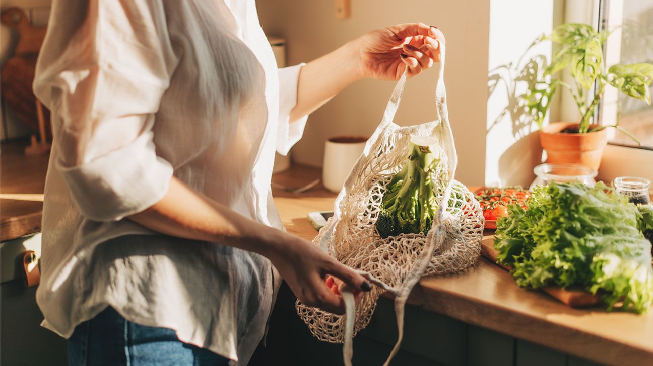 Produce in shopping bags in kitchen