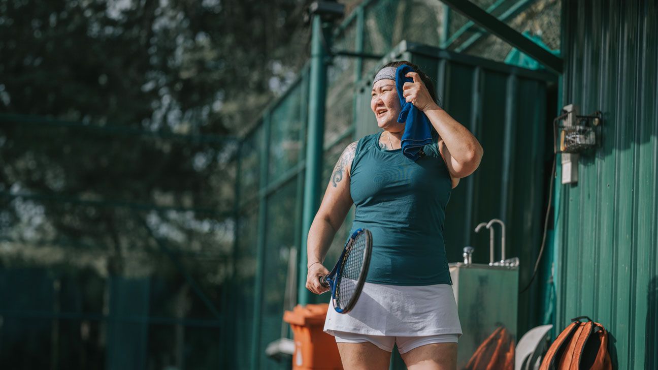 Female playing tennis in hot weather