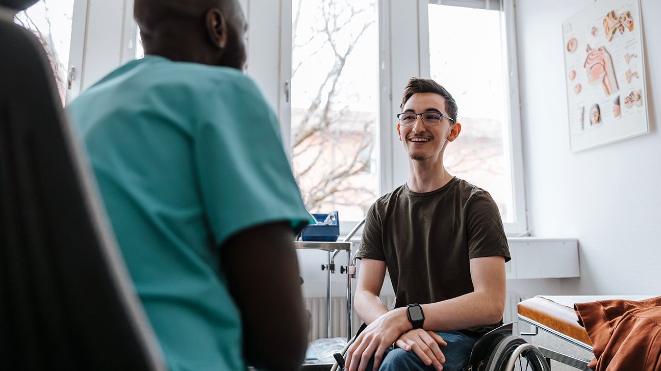 Patient in a wheelchair talking with their doctor