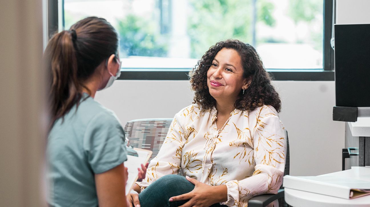 female in doctor's office speaking with a healthcare practitioner