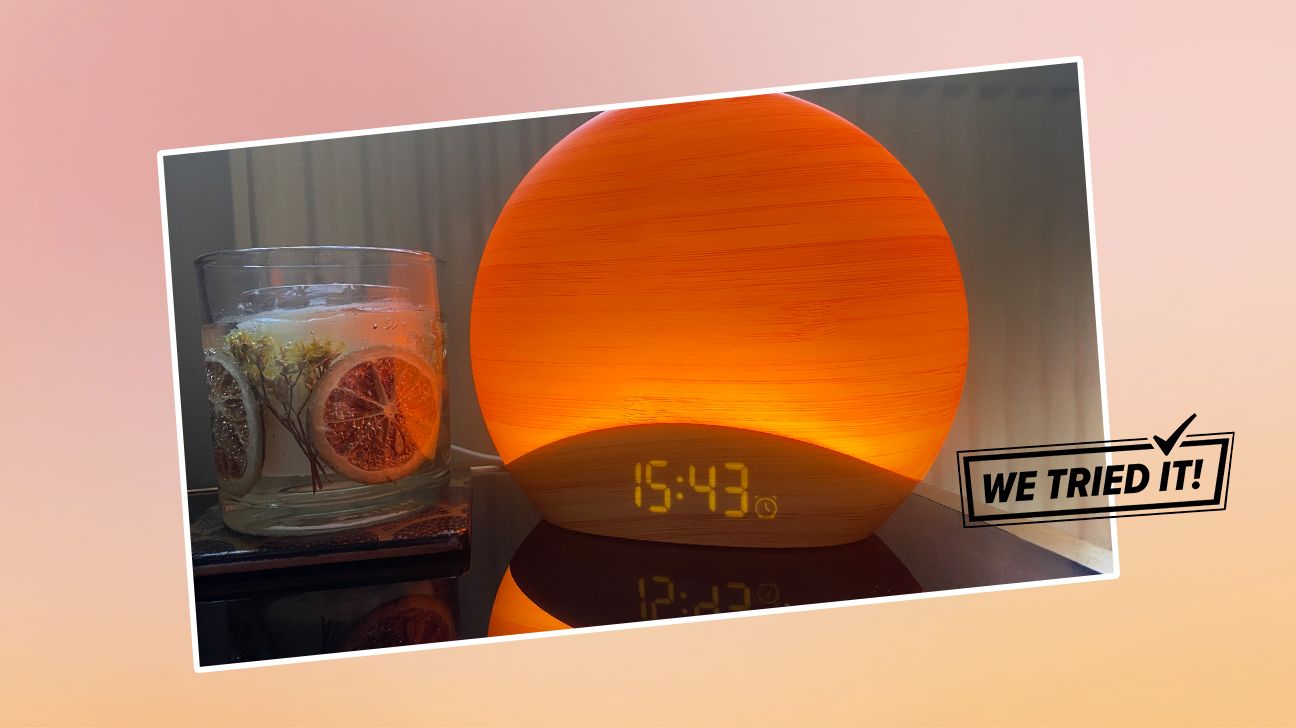 a sunrise alarm clock next to a glass of water with "I Tried It" logo