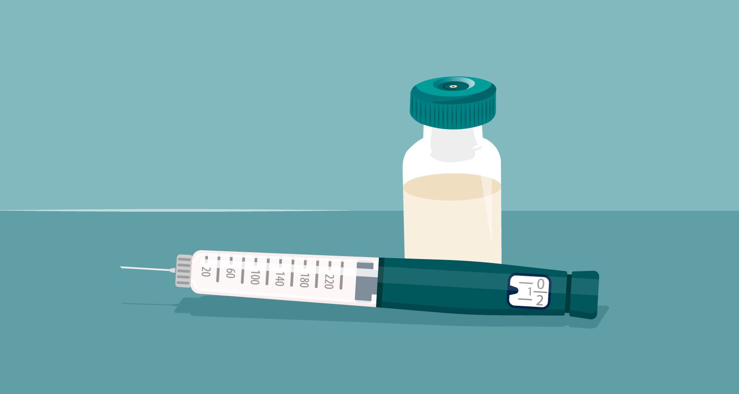 injection needle and vial of medication resting on a surface