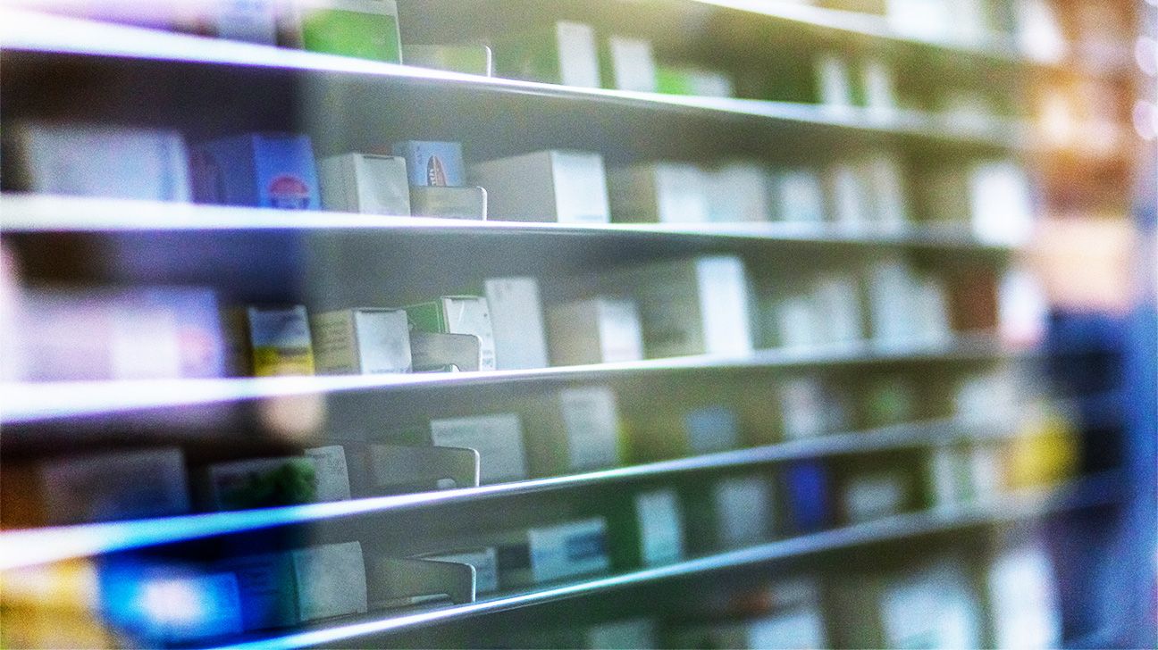 Slightly blurred image of medications on a pharmacy shelf