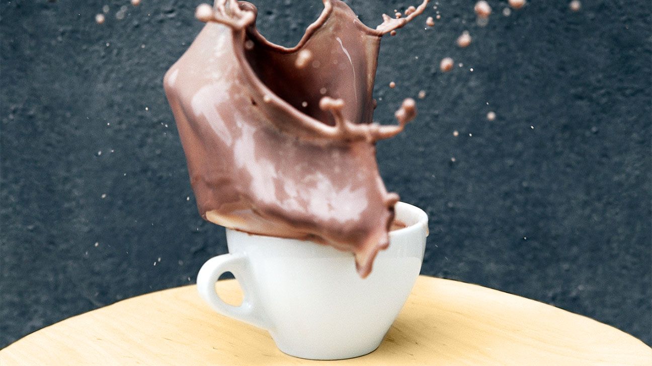 Hot chocolate splashing out of a white mug