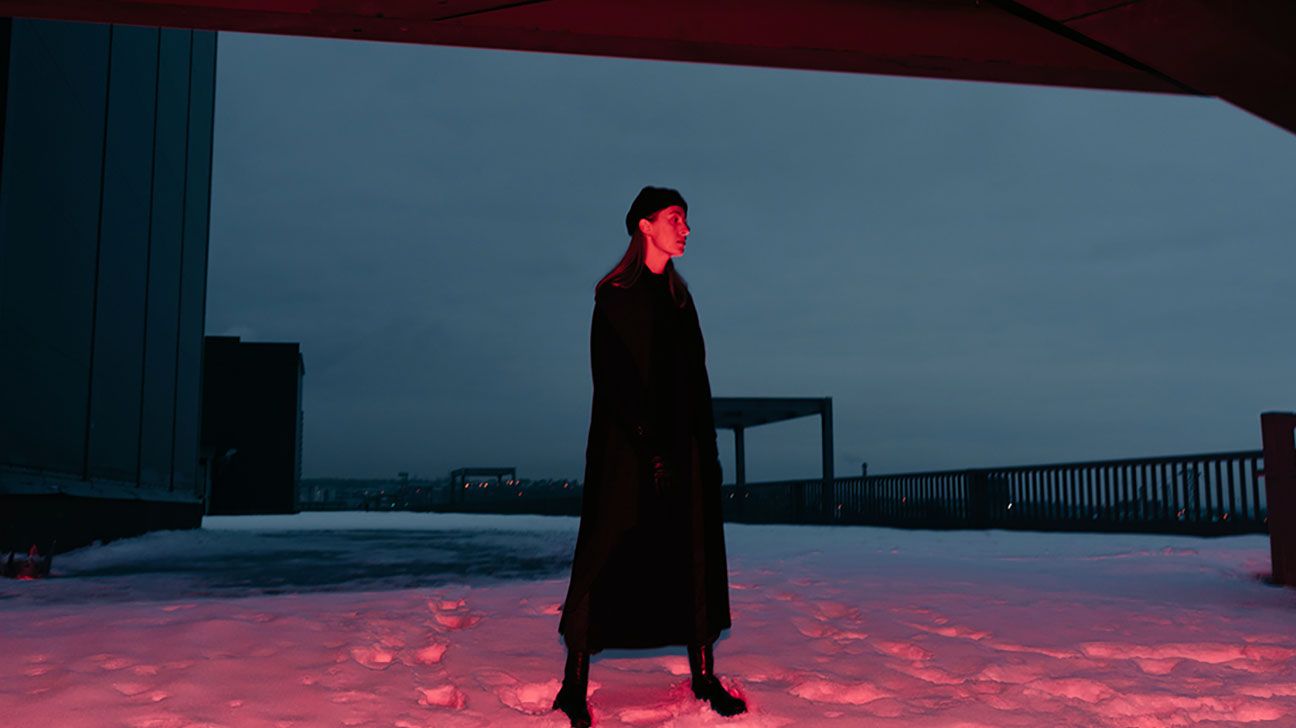 Person walks through snow at night