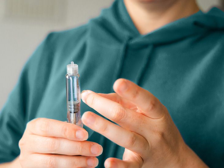 A person is holding an injection.