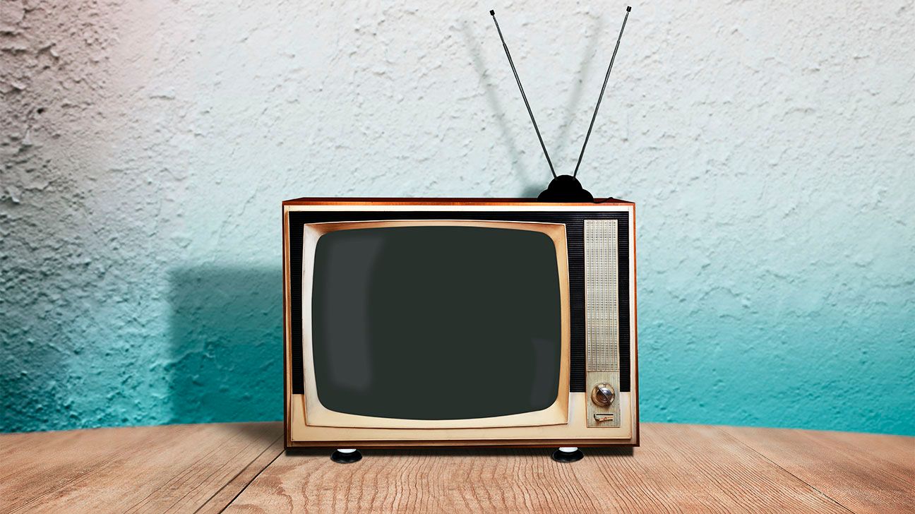 A retro tv against a blue and white wall