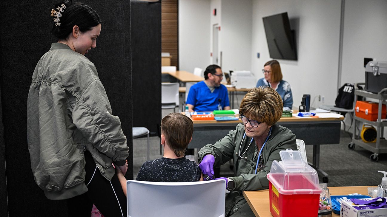 Child receives vaccine at clinic