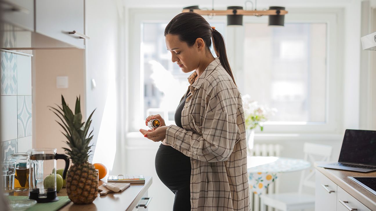 Female taking vitamins during pregnancy