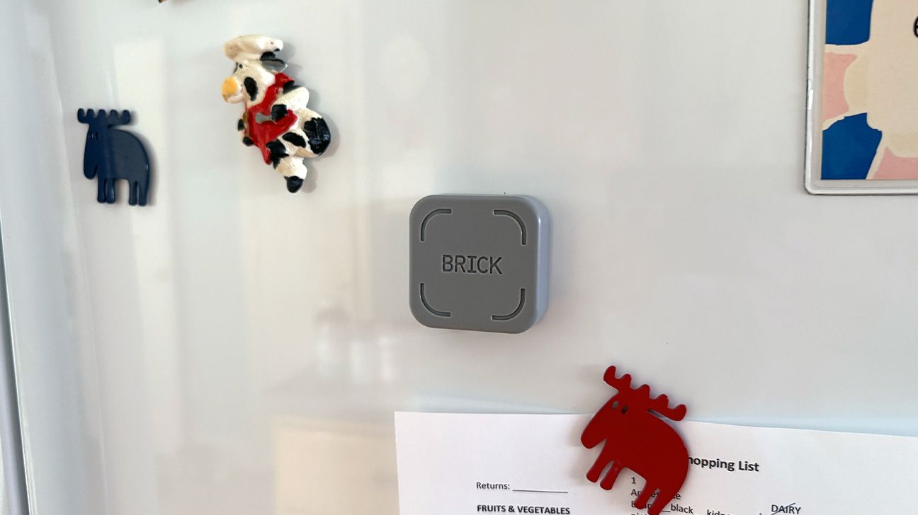 A Brick phone lock device magnetically attached to a refrigerator.
