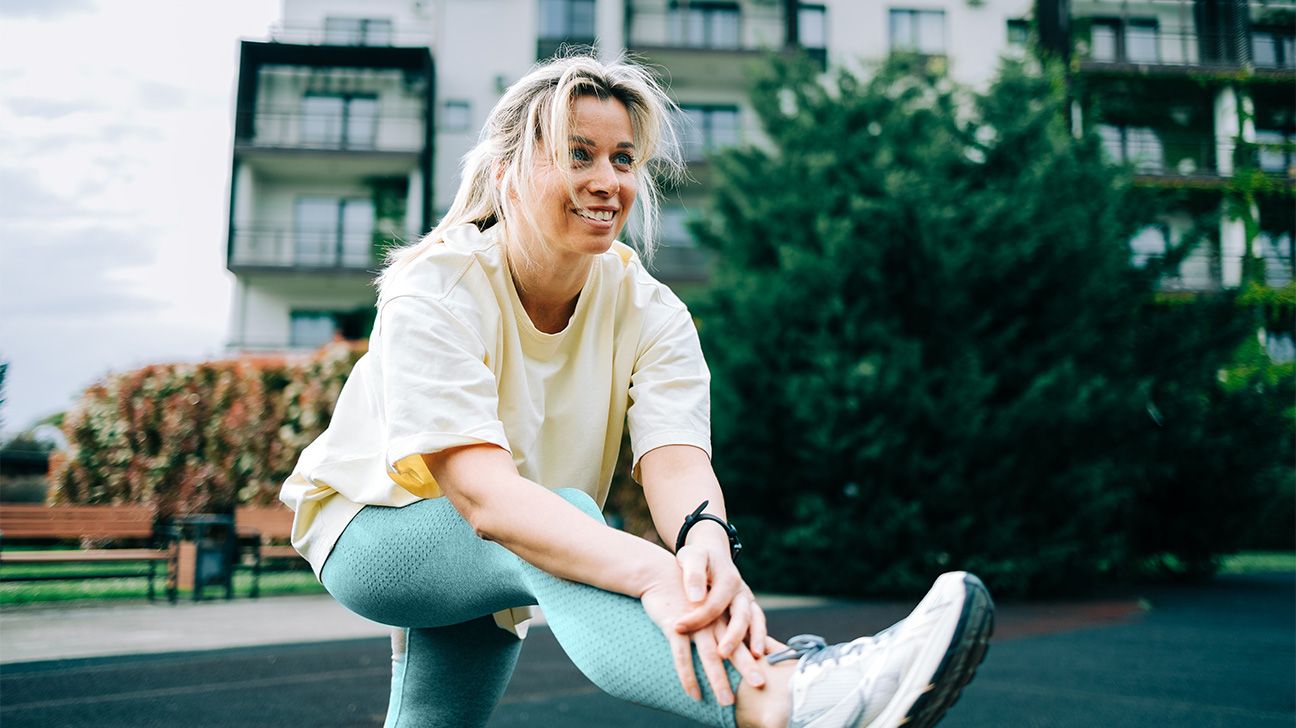 Female stretching leg outdoors