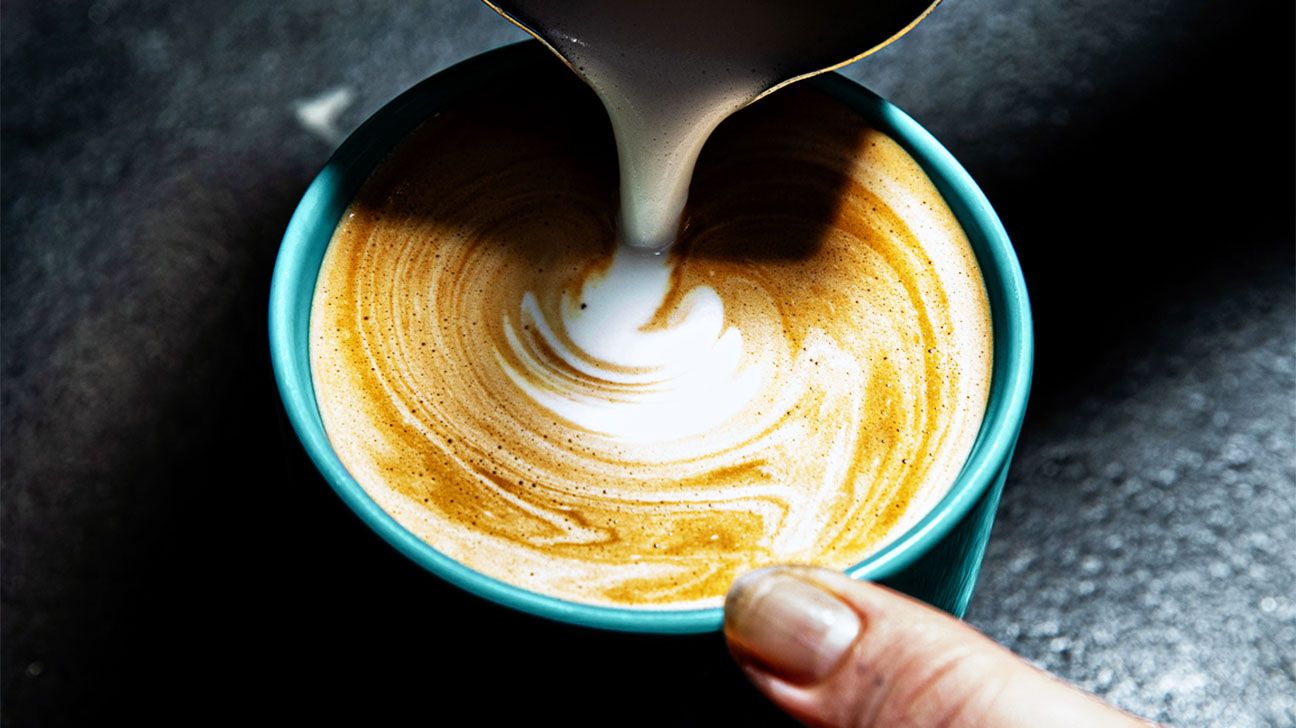 Pouring milk into a cappuccino 