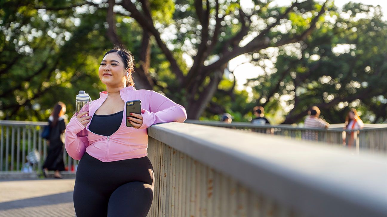 Curvy female exercising in a park