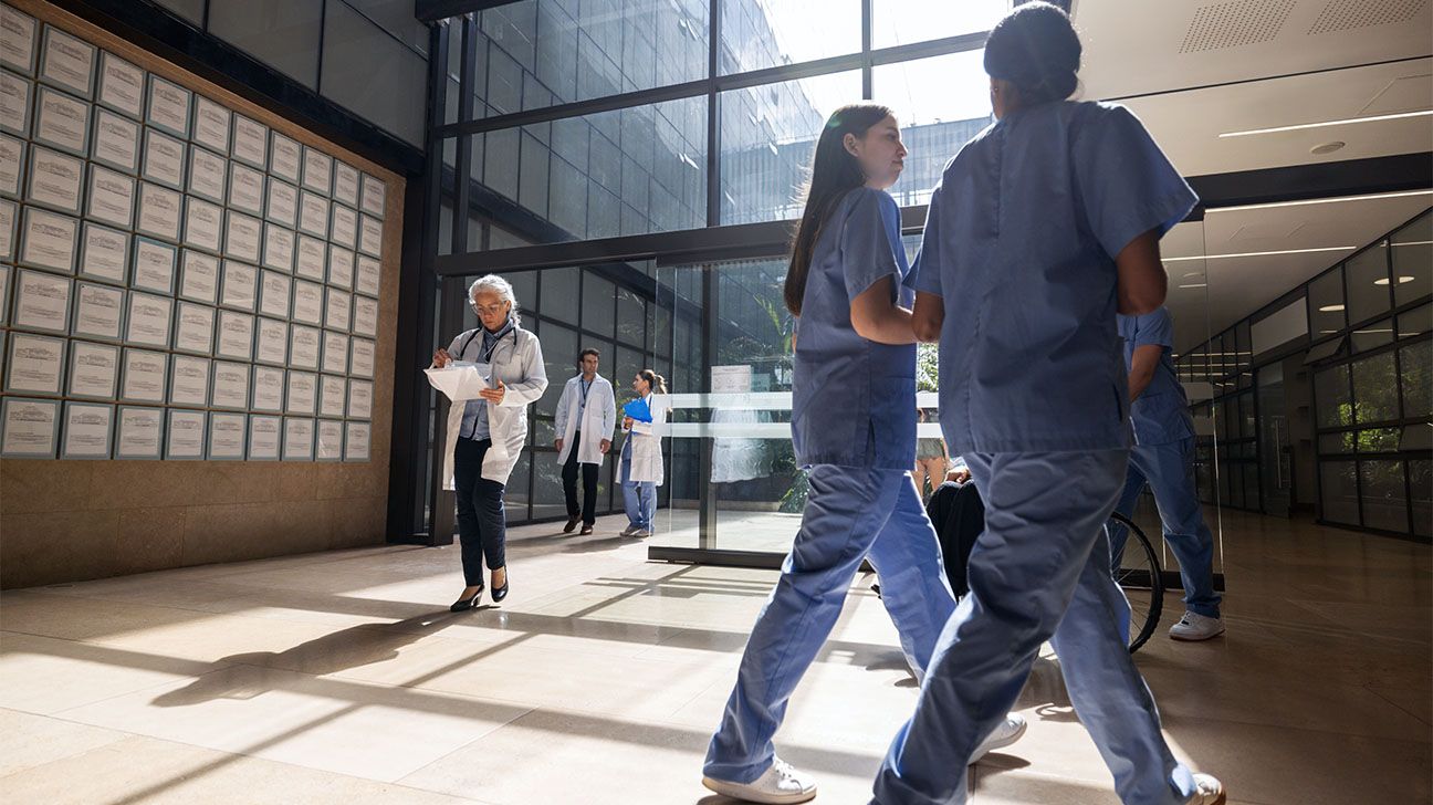 Healthcare professionals walking inside a building.