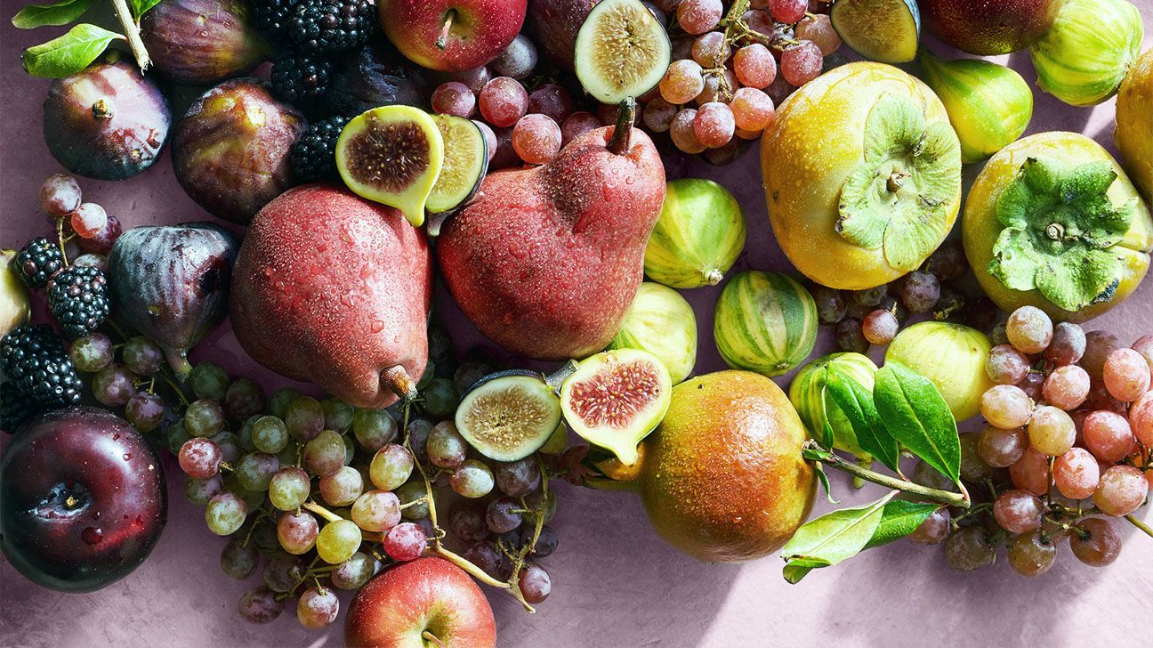 Various fruits against a pink background