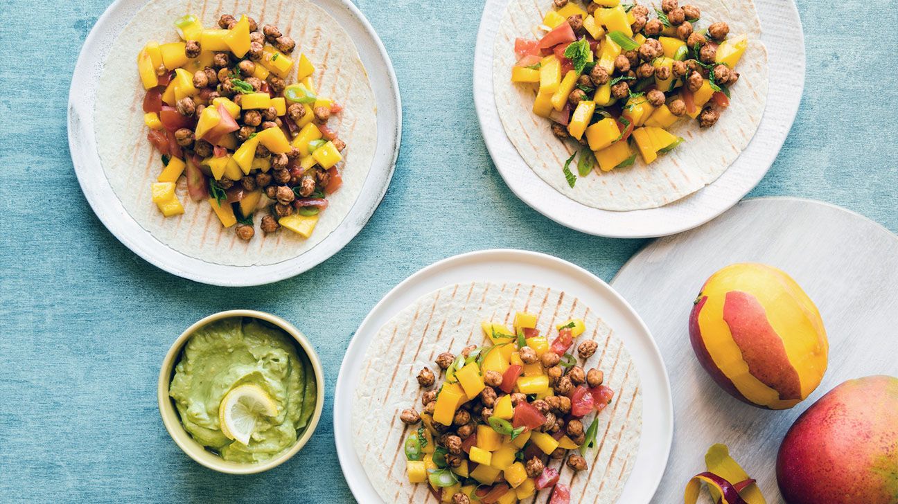 Mango and avocado salad on light blue table