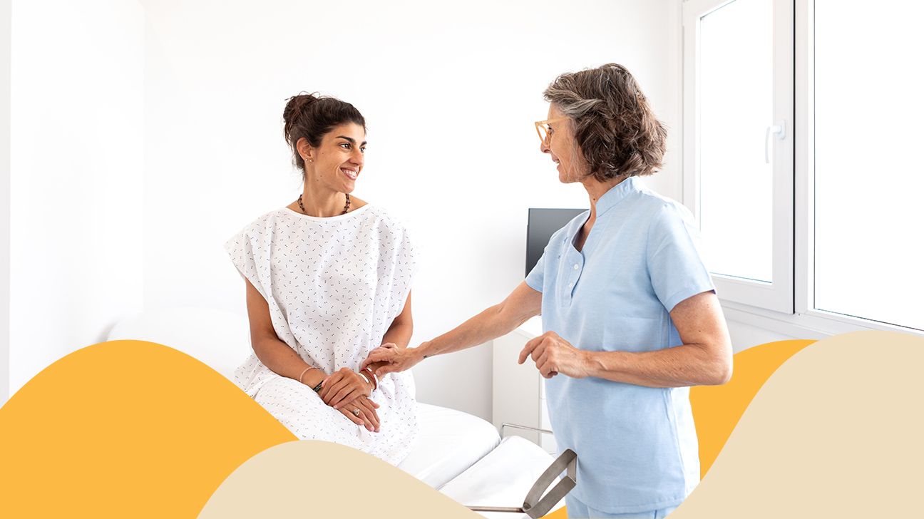 Female sitting in an exam room with a female doctor