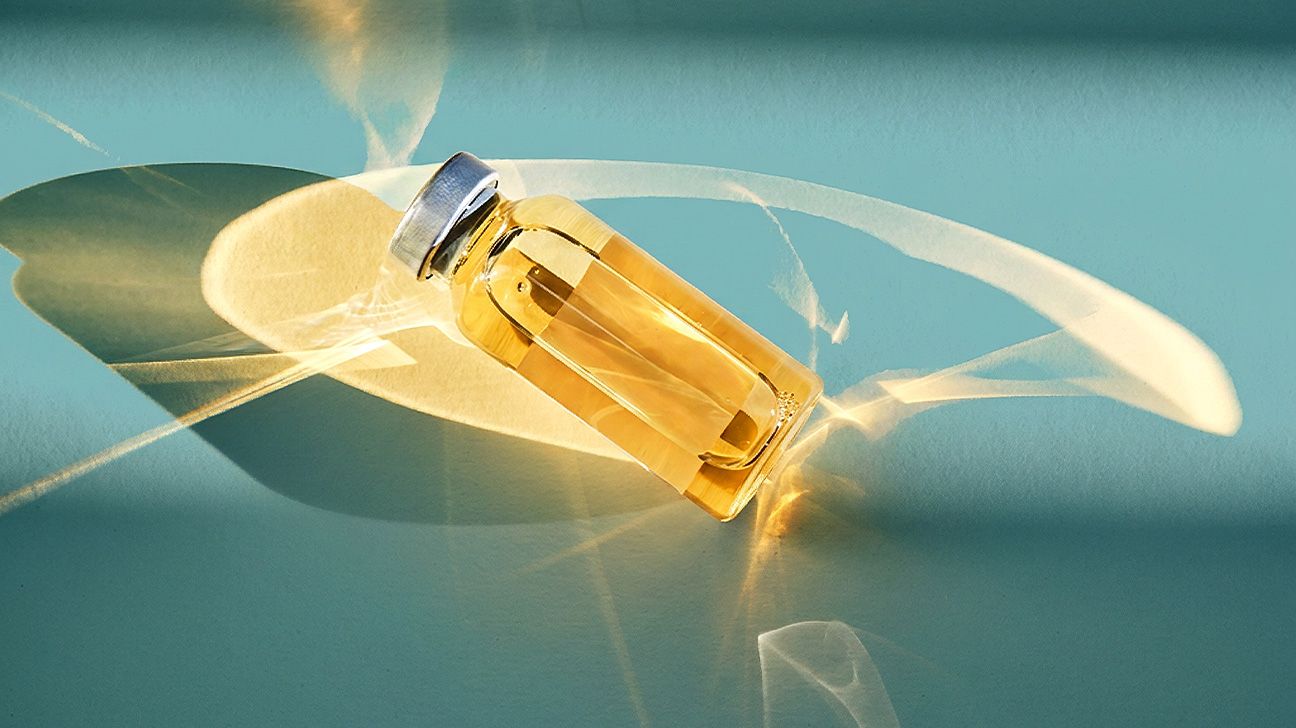 Wellness peptides in glass vial in golden light