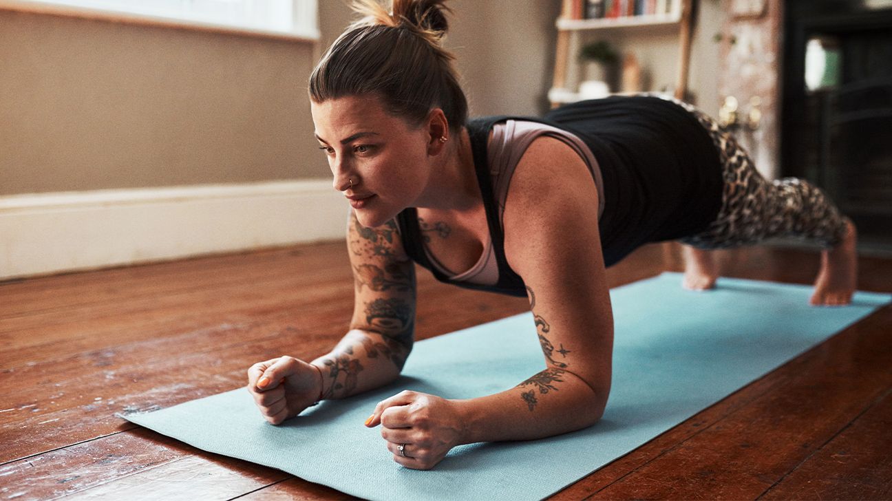 Female doing a plank in her living room