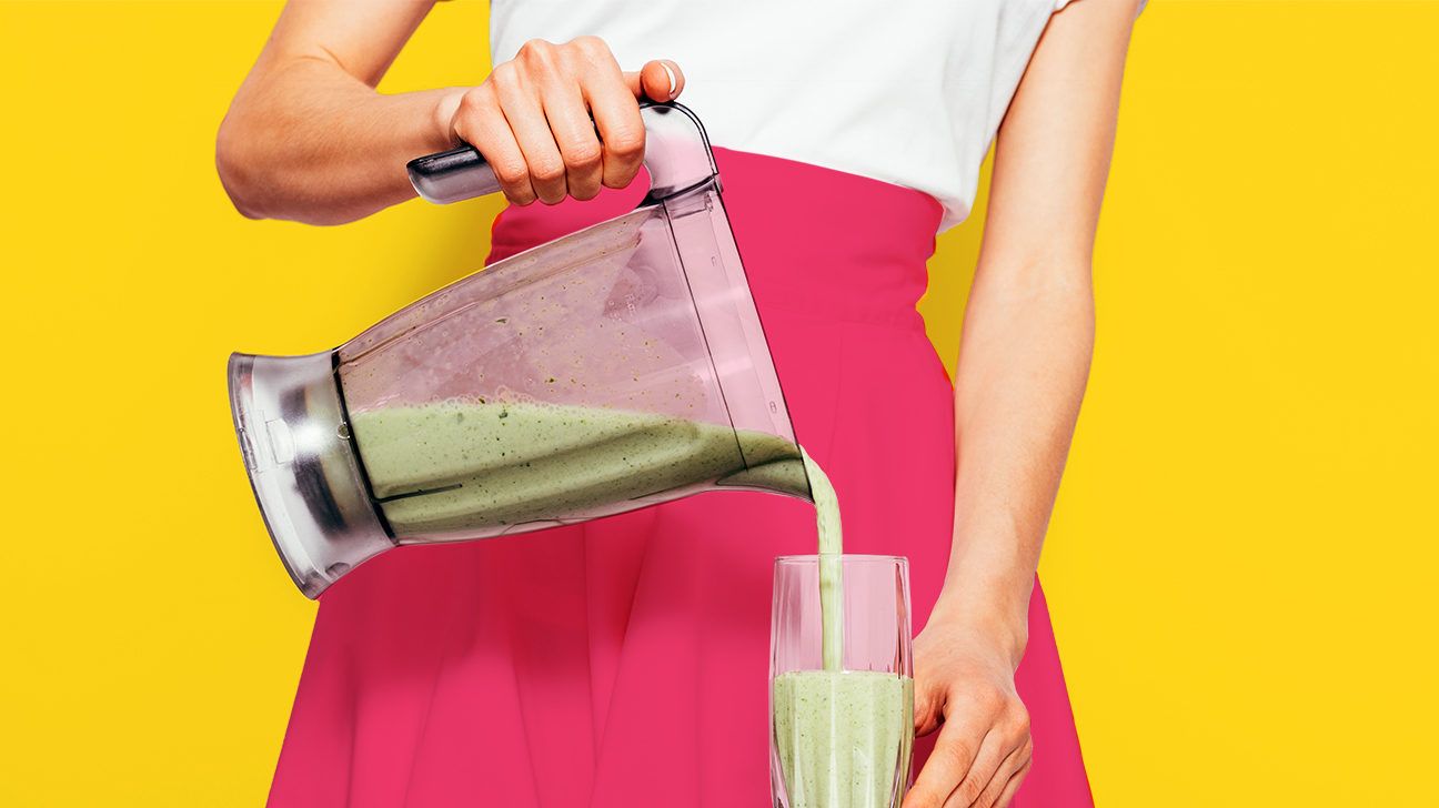 woman in a pink skirt pouring a smoothie