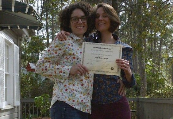 Kilby, the author, and her wife, Lindsay, with their marriage certificate