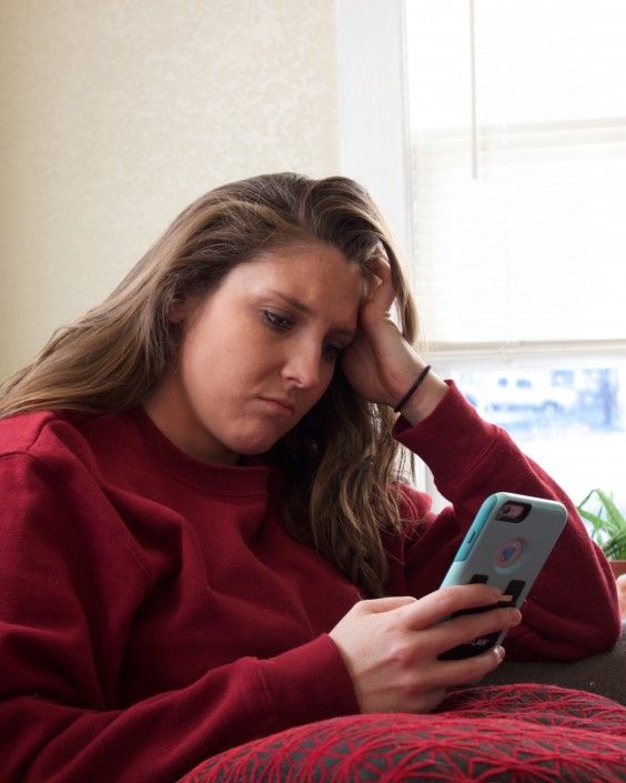 The author, Amanda, looking pretty displeased with the contents of her phone.