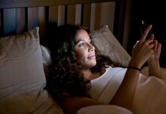 Woman With Smartphone in Bed