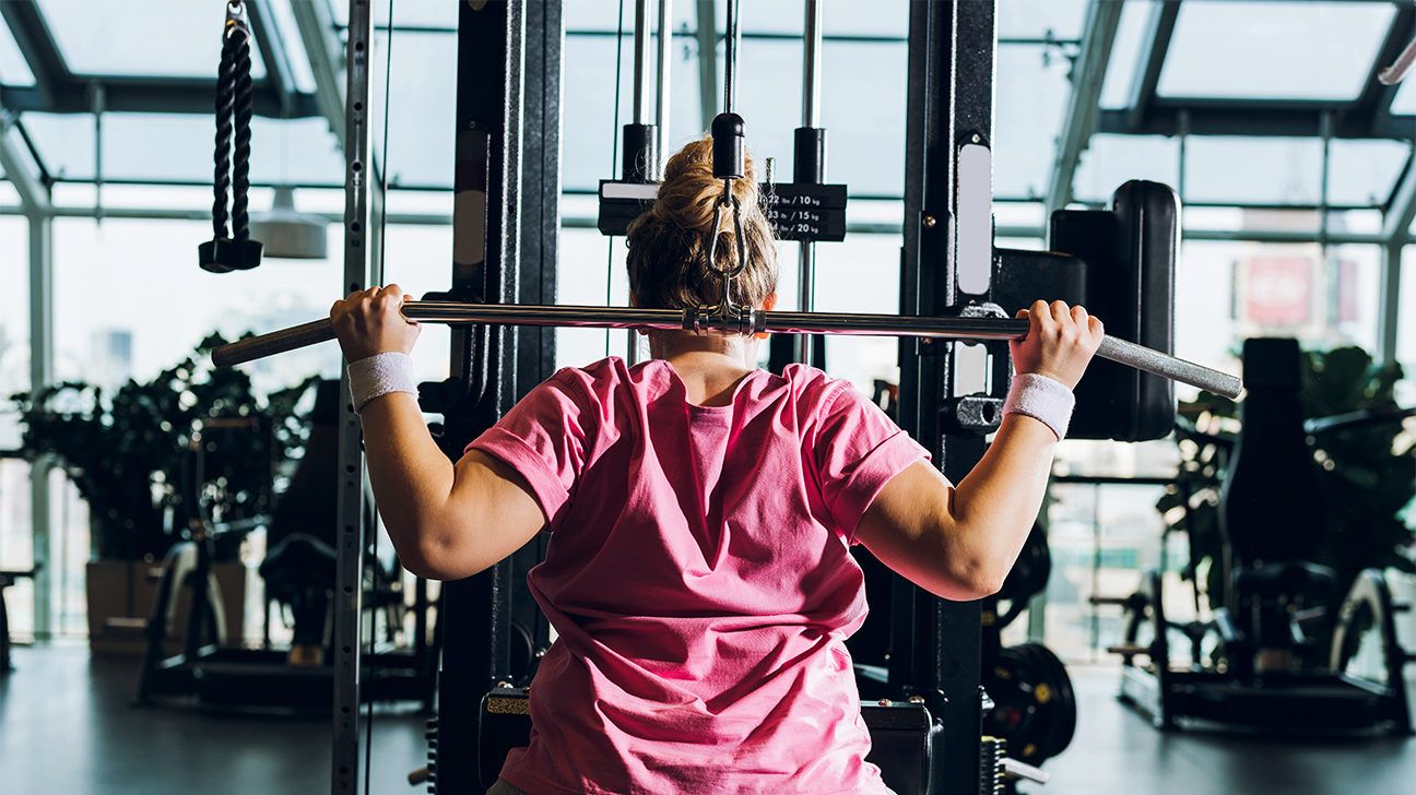 a woman using a gym machine wrong
