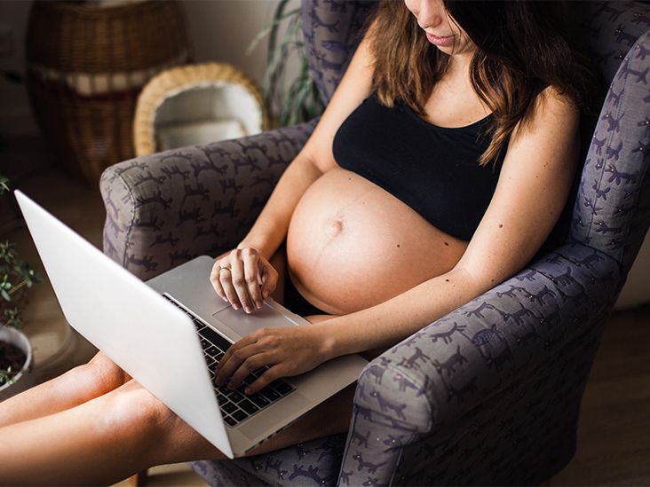 Girl with perfect booty in pink panties working with laptop on carpet at  home. Stock Photo