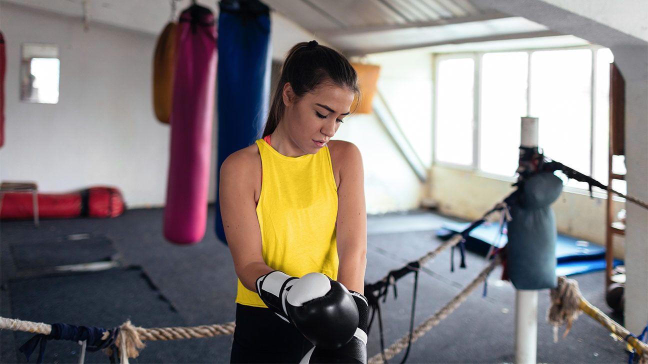 woman putting on kickboxing gloves