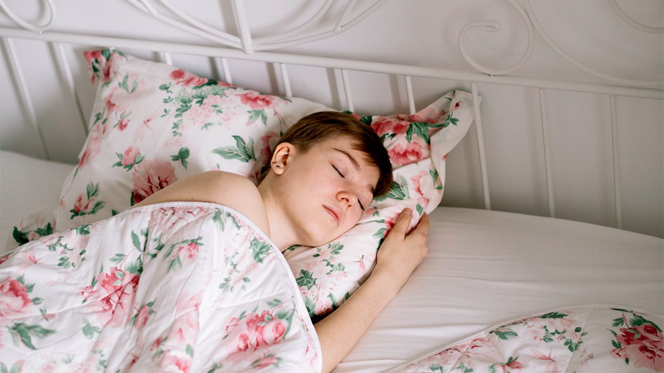 woman sleeping in floral sheets