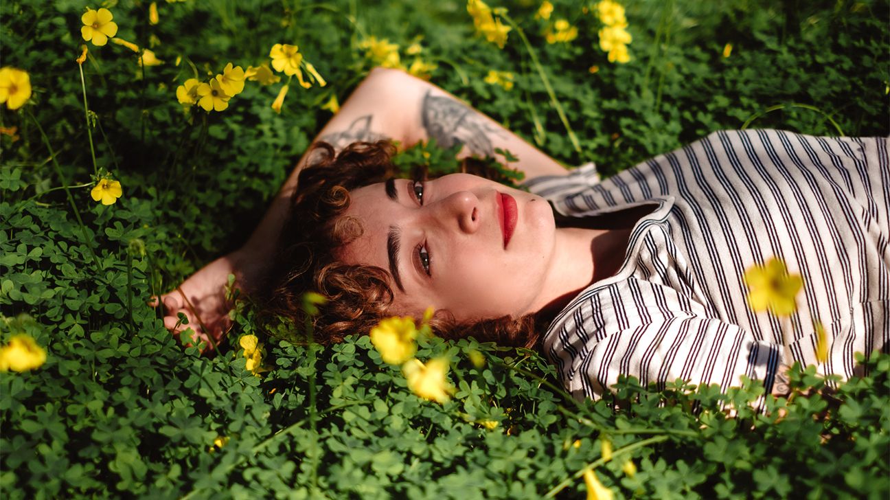 girl laying in a grove of wild flowers