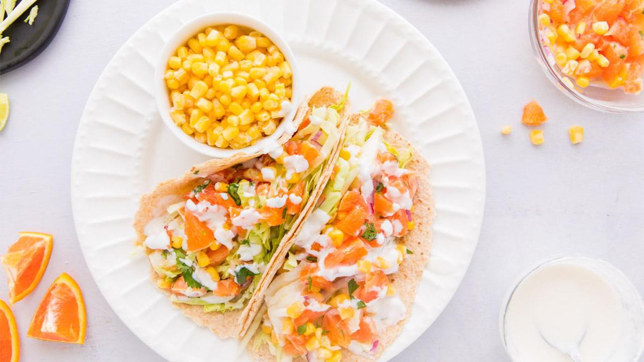 https://media.post.rvohealth.io/wp-content/uploads/sites/2/2020/06/1-fish-tacos-white-sauce-orange-salsa.jpg