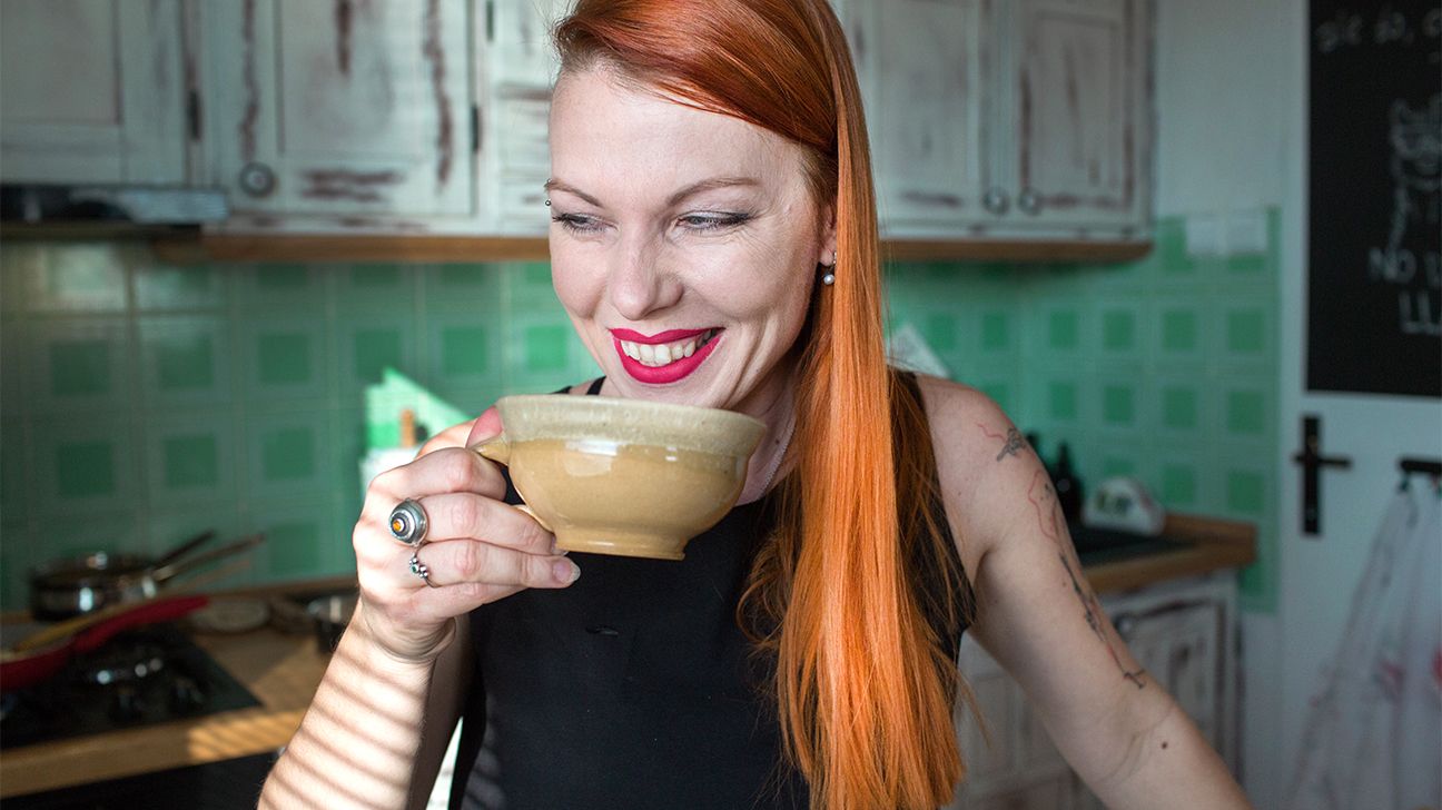 woman drinking coffee and smiling