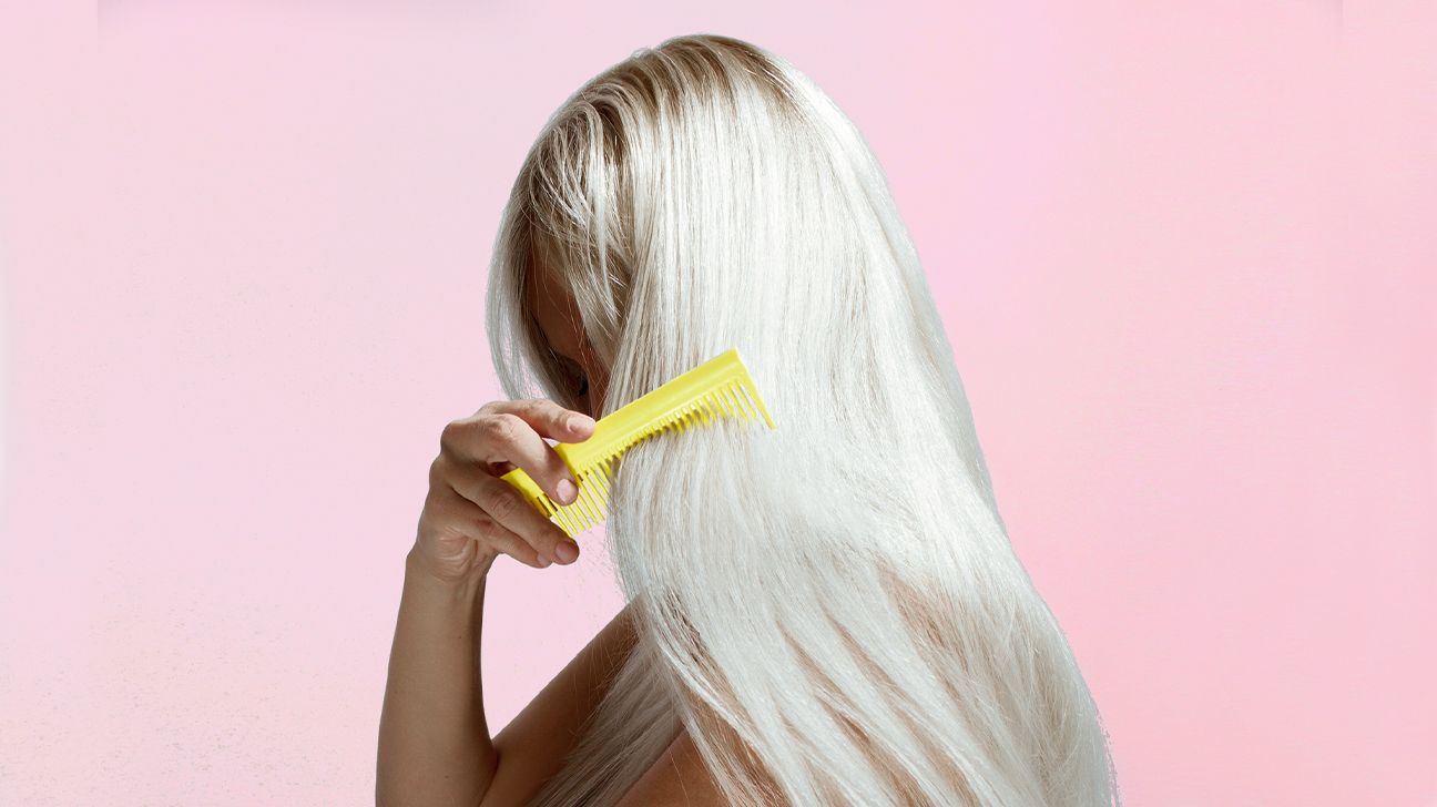 girl combing long blonde hair