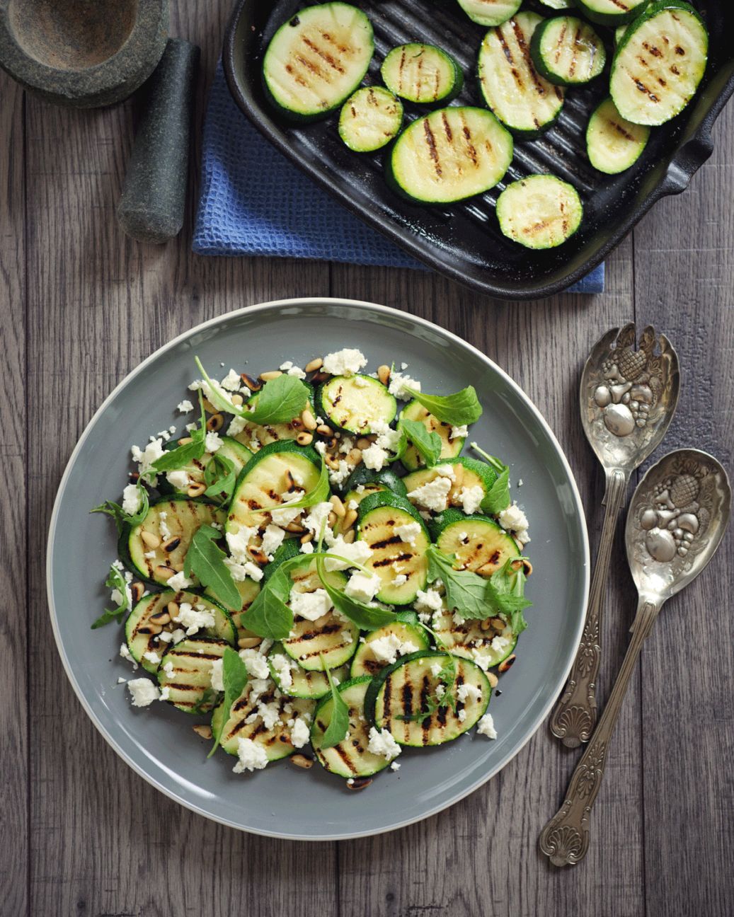 https://media.post.rvohealth.io/wp-content/uploads/sites/2/2020/08/186238-grt-22-Unexpected-Recipes-You-Can-Make-on-the-Grill13.Grilled-zucchini-with-lemon-and-feta-1037x1296.png