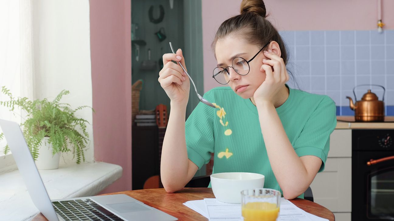 woman looks at cereal during sugar crash header