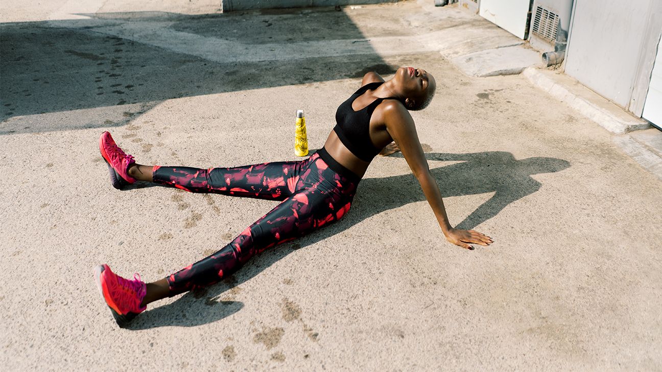 sportswoman resting after training on street 