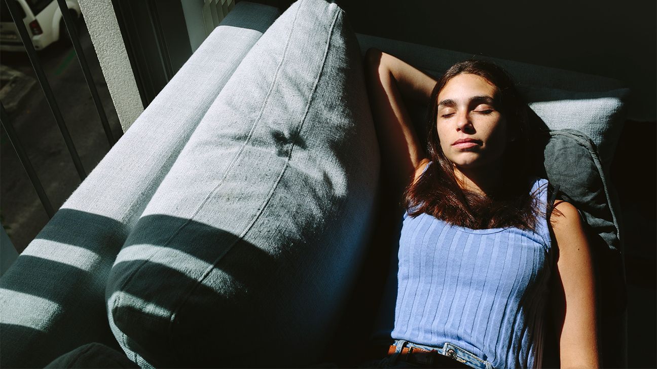 young woman sleeping on couch